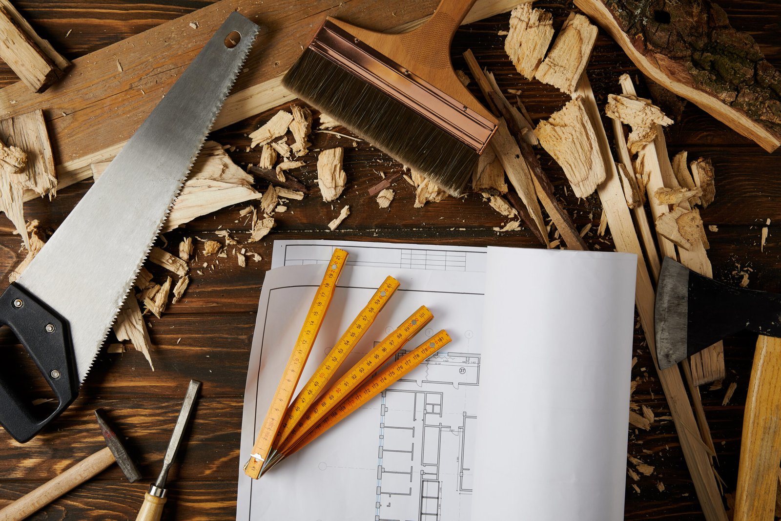 top view of blueprint and different tools on wooden brown table